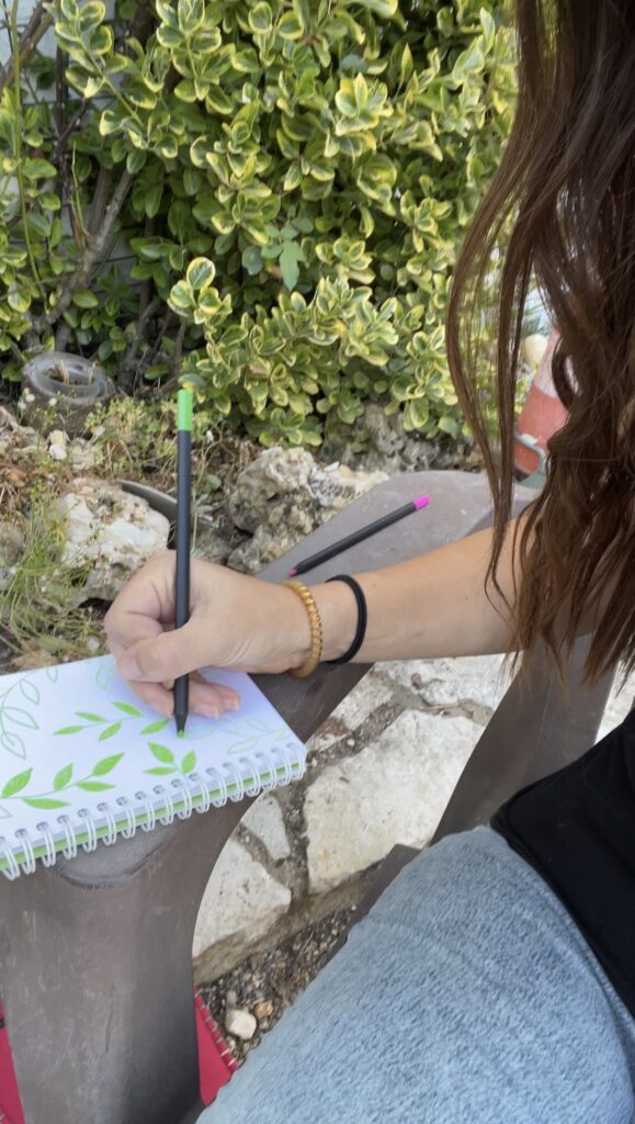 Camille drawing in the garden